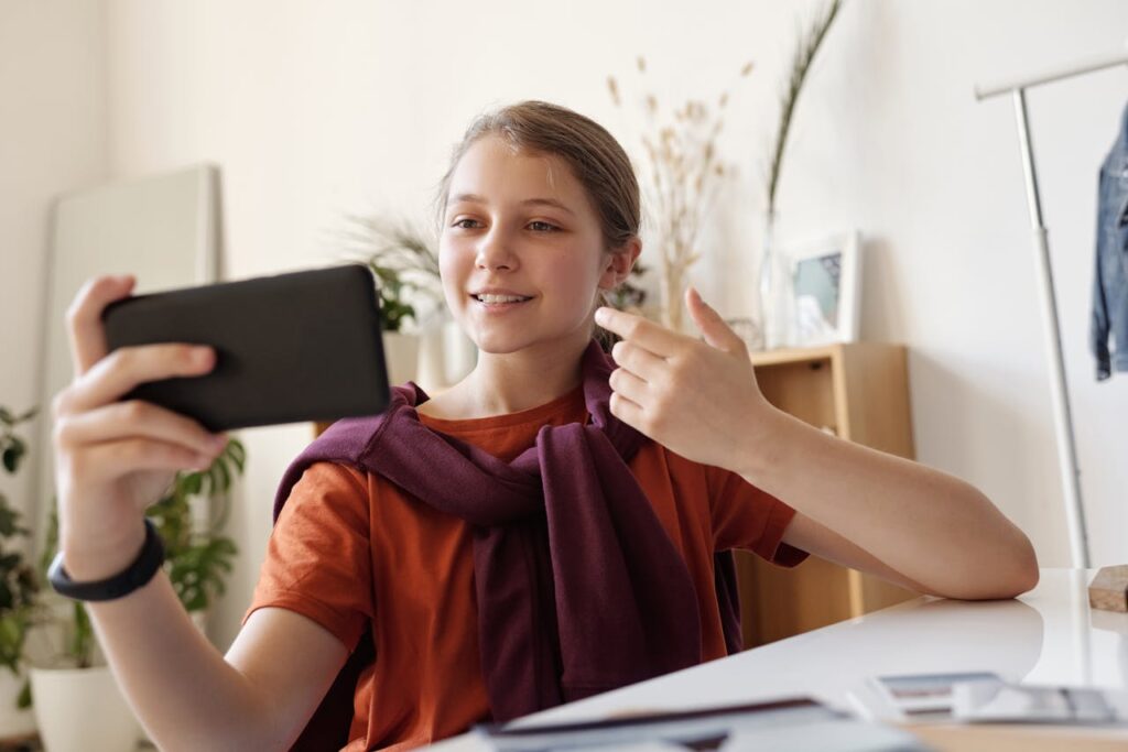 Photo of Girl Using Black Smartphone, social media marketing